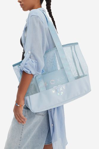 Modelka z dużą torebką shopper przewieszoną przez ramię.