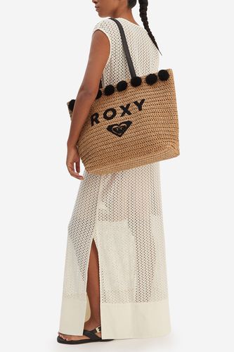 Modelka prezentująca torebkę shopperkę zawieszoną na ramieniu.