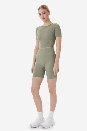 Modelka w komplecie sportowym, ujęcie całej sylwetki z przodu.